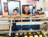 Regional Manager Greg Barton with pair of employees at the new Round Table Pizza Restaurant, located at 155 W. Hanford Armona Rd. in the Save Mart Shopping Center.